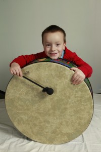 Banging a drum to hear and feel the rumble of the sound